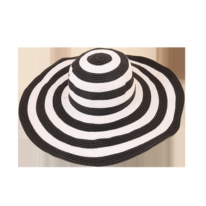 Fashionable oversized straw hat with classic black and white stripes for sun protection