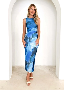 Detail of blue abstract print sleeveless maxi dress on model in minimalist white setting