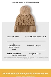 Detail view of khaki knit beanie with plush pompom and ribbed cuff for winter warmth
