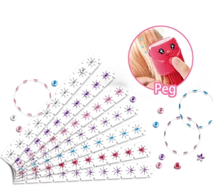 Detail of colorful gem strips and a red hair bedazzler tool for kids' DIY styling