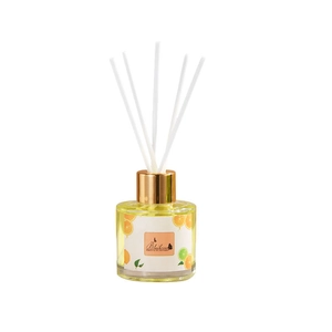 Fruity essential oil diffuser with rattan sticks in clear glass bottle and gold cap