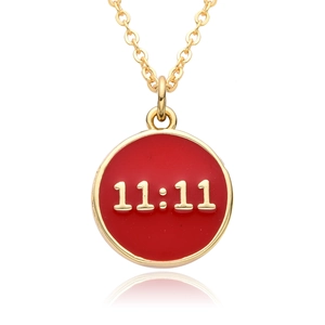 Macro shot of 18K gold plated pendant with red enamel and 11:11 numeric detail