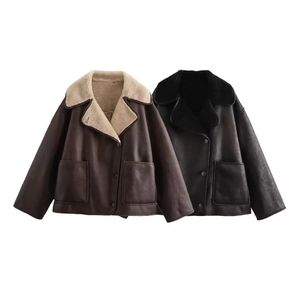 Detail of lapel shearling jacket featuring faux leather exterior and dual pockets