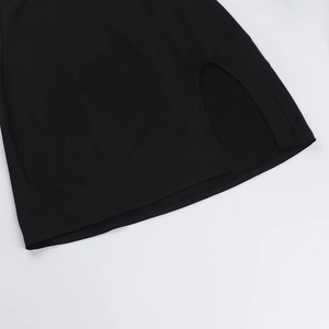 Detailed view of the black knit dress hem showing precise vertical split and clean stitching