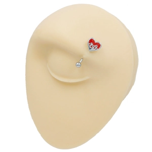 Macro view of stainless steel eyebrow piercing ring with red flame heart on silicone model