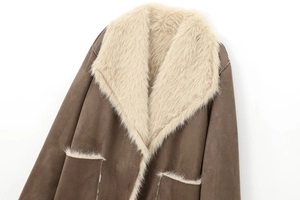 Detailed close-up of the dark brown suede coat featuring plush faux fur lining and pockets