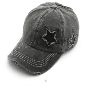 Detail of dark gray washed denim baseball cap with star patch and distressed stitching