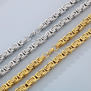 Detail showing two-tone Byzantine chain links in gold and silver finish with lobster clasp