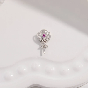 Detailed view of silver heart-shaped balloon pendant with a pink purple gemstone