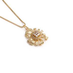 Golden necklace with irregular flower pendant featuring clear zircon crystals on thin chain