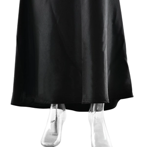 Detail view of black satin fishtail dress hem with elegant sheen and smooth texture