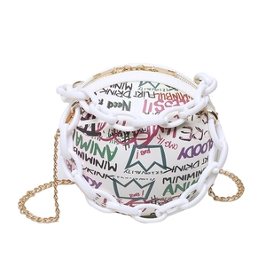 White basketball-shaped sphere bag with colorful graffiti and dual chain straps