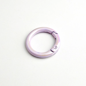 Macro detail of round light purple alloy spring ring with a metallic pearl finish