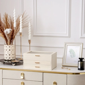 Elegant beige leather multi-layer jewelry organizer with glass top and gold handles