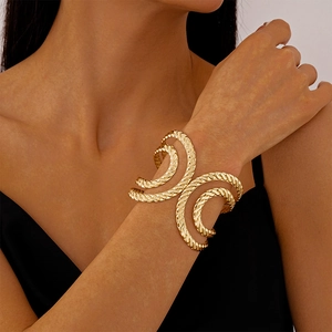 Detailed view of gold twisted rope cuff bracelet featuring double-layered textured metal