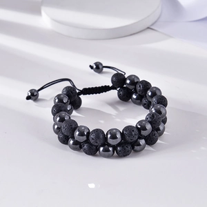 Macro detail of double-layer volcanic lava stone and hematite beaded bracelet with braided cord
