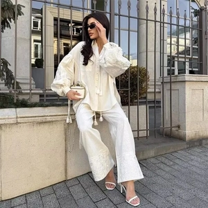 White linen blend two-piece set with long sleeve shirt and embroidered wide-leg trousers