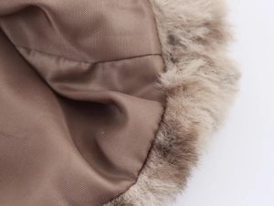Detail of soft leopard print faux fur and premium brown inner lining texture on the coat