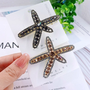 Elegant starfish hair clips with full crystal inlay in grey and amber on white cards