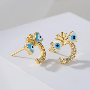 Gold bow earrings with blue evil eye charms and sparkling cubic zirconia stones
