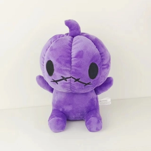 Detail of purple plush pumpkin with stitched mouth and white safety warning label