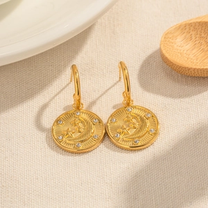 18K gold plated celestial earrings featuring moon and star charms with crystal accents
