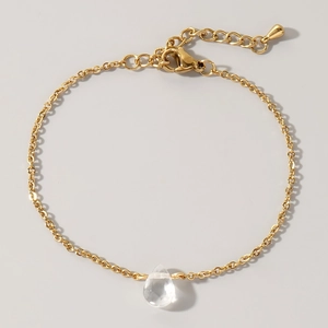 Detail of gold O-chain bracelet featuring a teardrop crystal pendant and lobster clasp