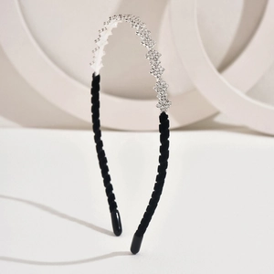 Detail view of crystal rhinestone headband with elegant black velvet fabric wrapping