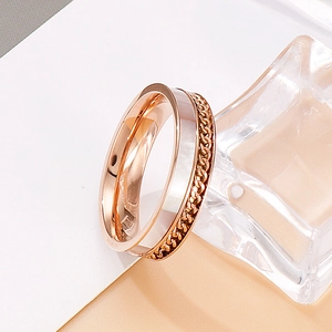 Macro view of rose gold titanium steel ring with woven chain texture and polished edges