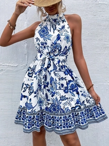 Close-up of halter floral dress with blue and white porcelain print and waist tie detail
