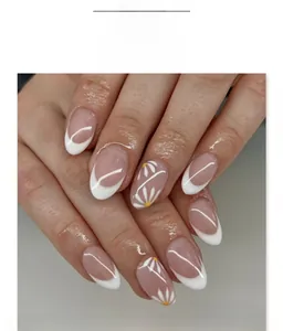 Detailed view of French white tip press-on nails featuring yellow daisy floral patterns