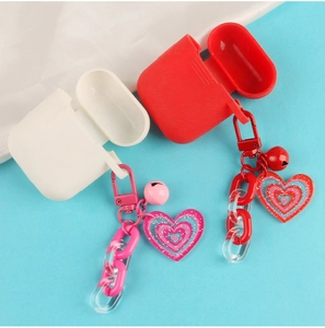 Detail of red and white silicone cases with heart charms and colorful acrylic chains