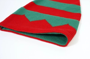 Close-up of red and green wavy striped knit texture on a Christmas beanie hat