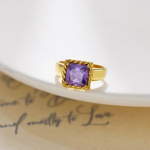 Macro view of French retro gold ring with square purple zircon and twisted rope border