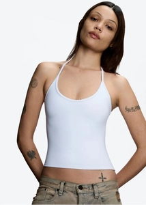 Front view detail of a white halter neck top with soft elastic texture on a model