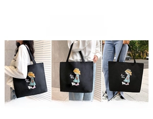 Black canvas tote bag showing three ways to carry: shoulder, hand, and arm hold styles