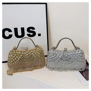 Detail of sparkling gold and silver rhinestone evening bags with fringe and metal handles