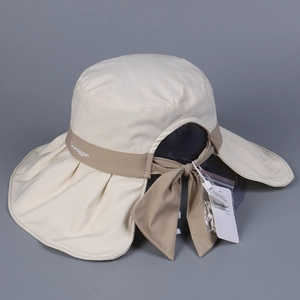 Detail of wide brim beige sun hat with back bow tie and embroidered brand logo