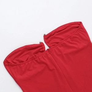 Detail of red strapless dress showing metallic silver beads and fine fabric texture