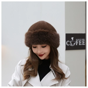 Detailed texture of brown faux fur winter beret hat with thick warm plush material