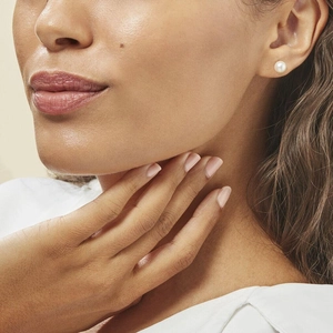 Close-up of a large white pearl stud earring on model showcasing natural luster