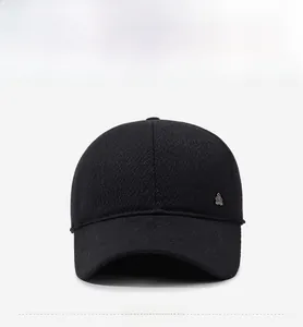Detailed close-up of a black winter baseball cap featuring textured wool fabric and a metal badge