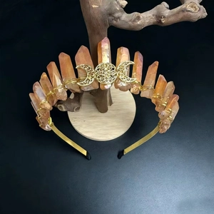 Detail of handmade crown featuring orange raw crystals and golden Celtic moon charms