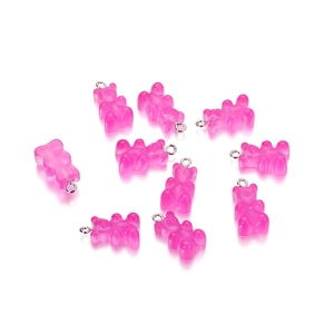Dettaglio di ciondoli a forma di orsetto rosa traslucido per gioielli fai-da-te