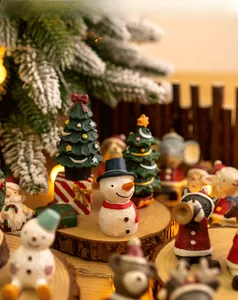 Detailed macro of festive resin Christmas miniatures on rustic wood with warm fairy lights