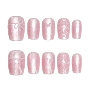 Pink press-on nails set with cat eye finish, bow charms, and quilted patterns