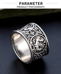Macro detail of wide punk ring featuring vintage silver dragon relief and black aged finish