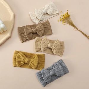 Set of five baby headbands with large bows in varied colors and cable knit texture