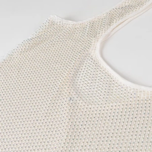 Détail du tissu en maille blanche avec strass étincelants sur une robe de soirée