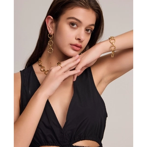 Close-up of golden geometric chain link jewelry set including necklace and earrings